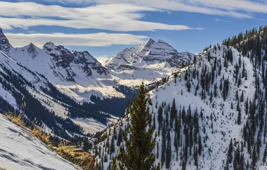 Foto op Canvas Beautiful view of Aspen, Snowmass mountain range, Colorado, USA, in winter  peaks are covered with snow and pines  blue sky with clouds in background © Lana