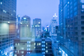 Blur image of city scape building in the night with light bokeh
