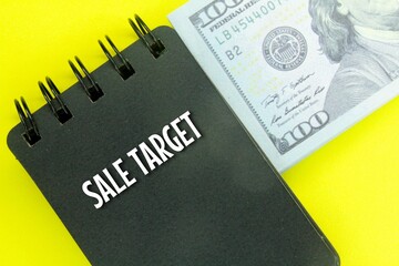 banknotes and notebooks with the words Sale Target