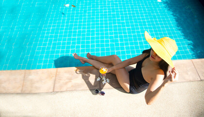 beautiful young asian woman relax smile around outdoor swimming pool in hotel resort nearly sea beach ocean