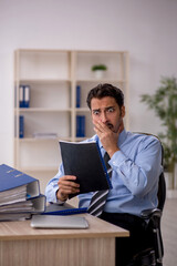 Young male employee working in the office