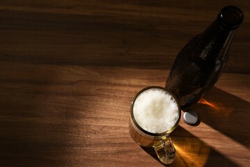 beer glass with bottle on wooden table