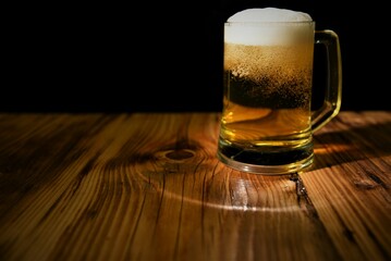 glass of beer on wood table