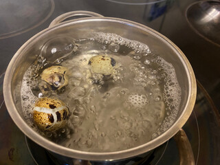 Quail eggs are boiled in a saucepan with water.Cooking quail eggs at home.