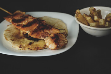 Delicious chicken skewer with French fries