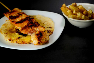 Delicious chicken skewer with French fries