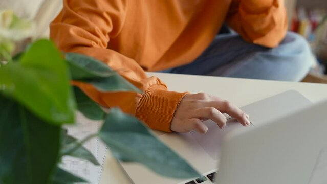 Teenager hands on computer keyboard in foreground, woman or student relaxed or using panoramic banner, online learning, internet marketing and freelance work concept.