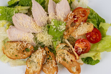 caesar salad on white background. Close up image of delicious ceasar salad white background. Chicken Caesar Salad