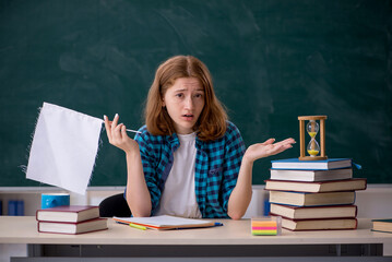 Young female student in time management concept