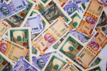 American one hundred dollar bill and Indian paper currency banknote on table as a backgrounds.