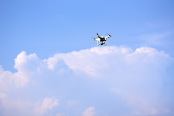 Close-up of drone is flying against isolated blue sky