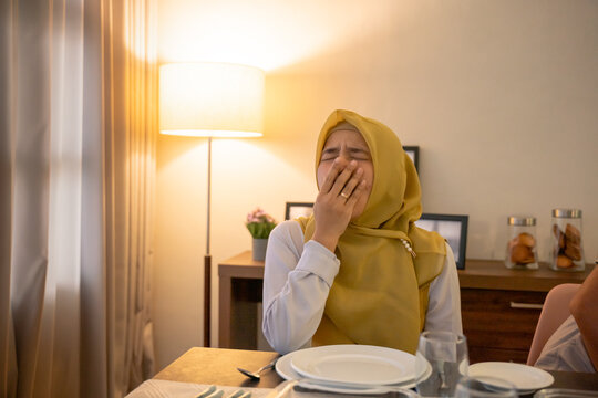 tired woman having break fast or sahur in the morning