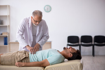 Young male patient visiting old male doctor