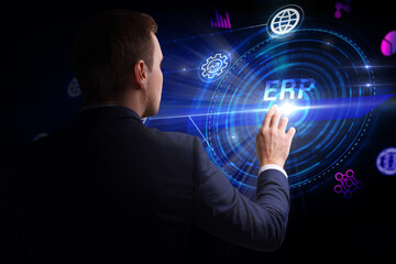 Business, Technology, Internet and network concept. Young businessman working on a virtual screen of the future and sees the inscription: ERP