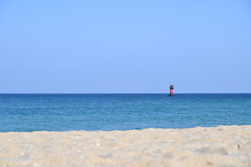 Beautiful beach and a lighthouse that can be seen far away