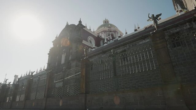 Pov tilt up of famous Puebla Cathedral with grid and bright sunny day in background,Mexico