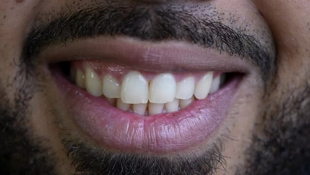 A casual hispanic man smiling close-up macro smile