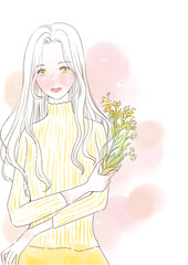 菜の花を持って微笑む女性