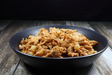 Traditional fried pork sliced with Gochujang (Korean sauce) serving on the plate. Famous comfortable food menu in Asia restaurant. 