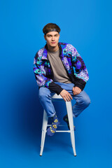 Male casual outfit - windbreaker jacket, olive shirt, jeans and socks with print - obrazy, fototapety, plakaty