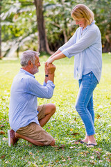 Fototapeta premium Propose happiness couple elderly caucasian relax weekend lifestyle in park, Retirement Plan.