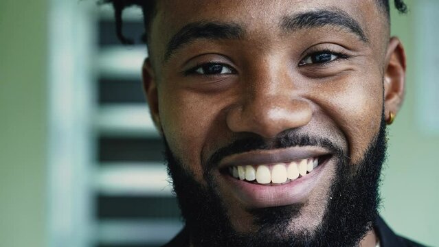 A joyful black man portrait face smiling at camera