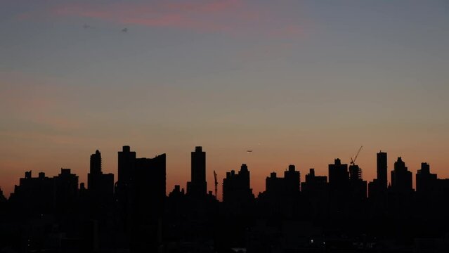 sunset in the city with skyline silhouette
