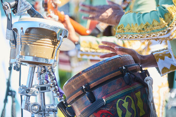 Musical instrument Brazilian drums for the performance of national music. Percussion. Male hands of a musician.