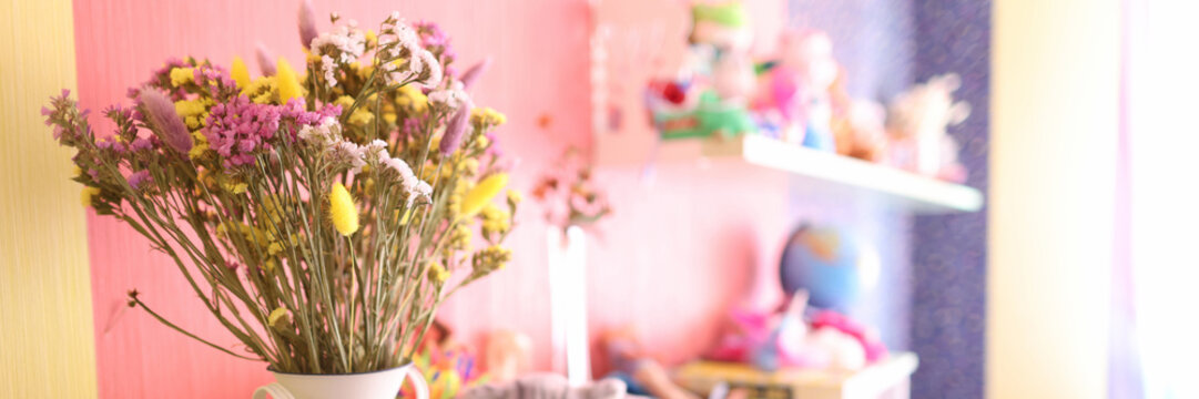 Dried flowers for decoration are in vase in children room closeup