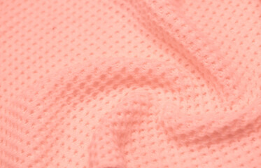 Knitted surface of woolen things as a background. Close-up soft pink color knitted patterns texture. Warm winter clothes. Background textile surface with copy space for text.