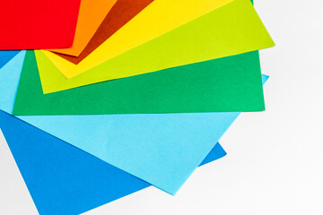 白い机に並べられた色とりどりの紙