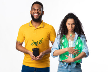 Couple Holding Green Plant And Wasted Plastic Bottles, White Background