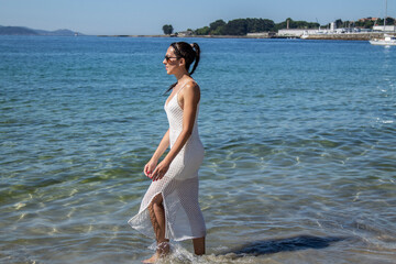 Vacation Resort Lifestyle. Beautiful young woman walking on tropical beac
