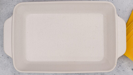 White baking dish close up on light grey background