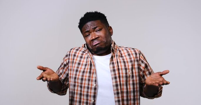 Confused man gesturing I don't know or can't help anything over white background