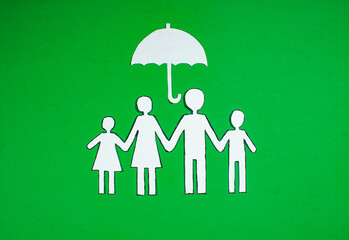 a family of four on a green background. insurance concept with places for inscriptions