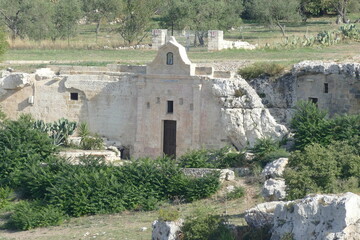 Madonna delle Vergini rupestrian church in Murgia Materana Park with an arched entrance carved into the rock introducing in the cave