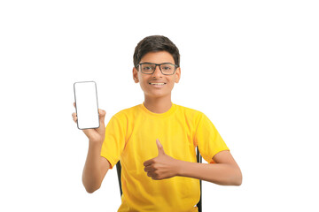 technology concept: Cute indian little school boy showing smartphone