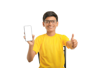 technology concept: Cute indian little school boy showing smartphone