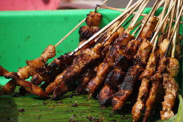 Sate (indonesian skewer) with a natural background. Sate is one of traditional Indonesian food which served with peanut sauce