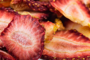 sliced pieces of dried strawberries, as a background, close-up