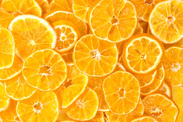 sliced pieces of dried oranges as a background, close-up