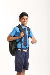 Indian school boy standing on white background.
