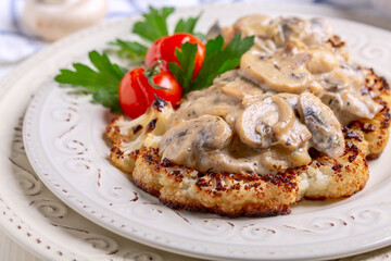 Cauliflower steak with mushrooms. Vegetarian cuisine.
