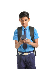 indian school boy using smartphone on white background.