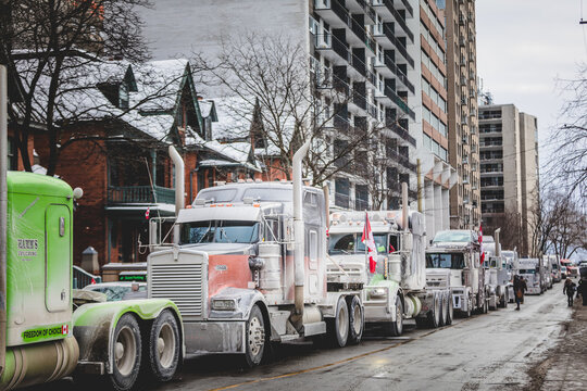Convoy for Freedom 2022 Trucks and Tracors Protesting in the Streets with Flag and Signs.