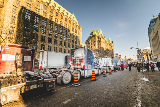 Convoy for Freedom 2022 Trucks and Tracors Protesting in the Streets with Flag and Signs.