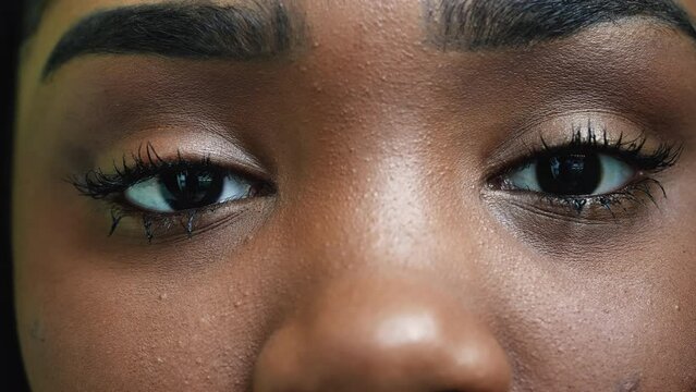 An African young woman macro eyes close-up looking at camera