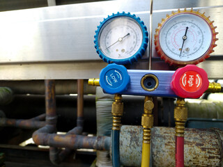 industrial tool pressure manifold gauge to checking refrigerant pressure on the refrigerant machine.