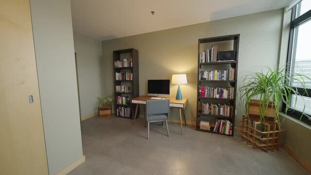 Office with Book Shelves in a Modern Condo Building with a Desk and Chair